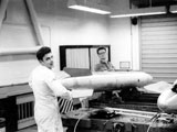 Gerry Beisel picking up tail end of B61. Bill Woodward in background.