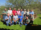 Group photo of guys. Kneeling in front: Chuck, Craig, Woody, Troy & Steve B. Standing in back: Bob R., John, Bake, Jim, Steve C., Steve L., Sam & Bob S.