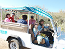 The Bakers and Jenkins in the jeep with Pauline Bisel riding shotgun