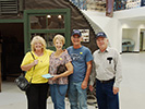 The Woodwards and Schabels pose by Quonset hut in the 390th Memorial Museum