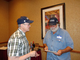 Steve Carr presents the pin to Steve Bisel