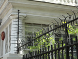 Photo of iron spikes on top of fence at a historic house. Many residents added these as security features after a slave uprising in 1822